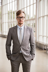 Image showing young businessman in suit and glasses at office