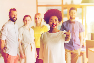 Image showing woman pointing to you over creative office team