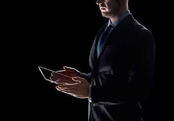 Image showing close up of businessman with transparent tablet pc