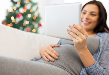 Image showing close up of pregnant woman with tablet pc at home