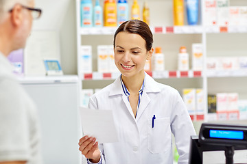 Image showing pharmacist reading prescription and senior man
