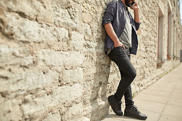 Image showing close up of man calling on smartphone in city