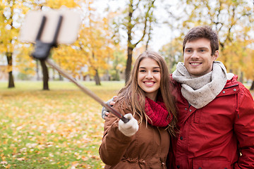 Image showing couple taking selfie by smartphone in autumn park