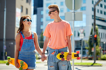 Image showing teenage couple with skateboards on city street