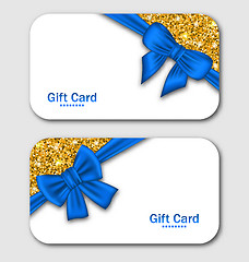 Image showing  Gift Cards with Blue Bow Ribbon and Golden Surface