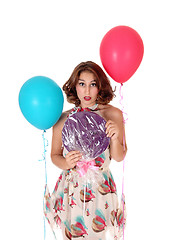 Image showing Beautiful woman with lollypop and balloons.