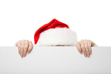 Image showing Christmas woman in santa hat holding empty board