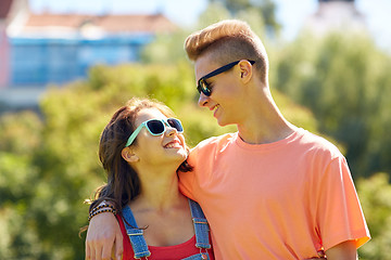 Image showing happy teenage couple looking at each other in park