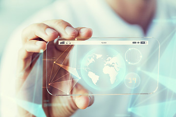 Image showing close up of hand with earth globe on smartphone