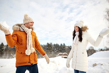 Image showing happy couple playing snowballs in winter