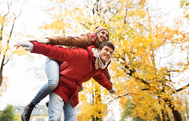 Image showing happy young couple having fun in autumn park