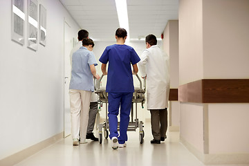 Image showing medics carrying hospital gurney to emergency room