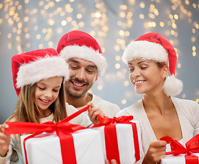 Image showing happy family with christmas gift boxes