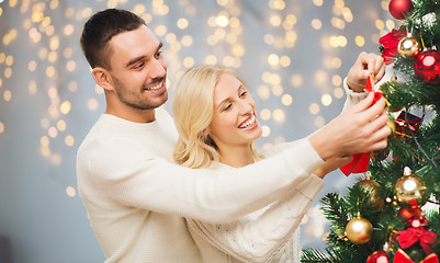 Image showing happy couple decorating christmas tree