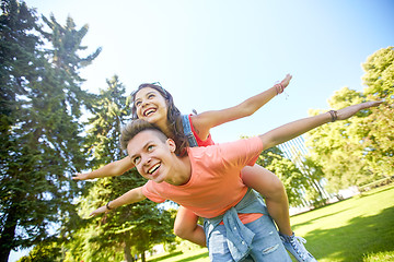 Image showing happy teenage couple having fun at summer park