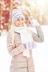 Image showing smiling young woman in winter forest