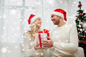 Image showing happy couple at home with christmas gift box