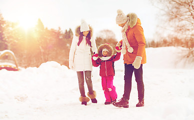 Image showing happy family in winter clothes walking outdoors