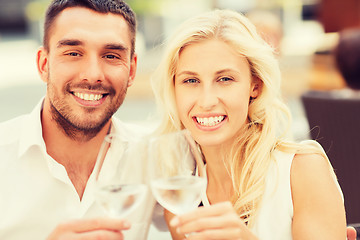 Image showing happy couple clinking glasses at restaurant lounge