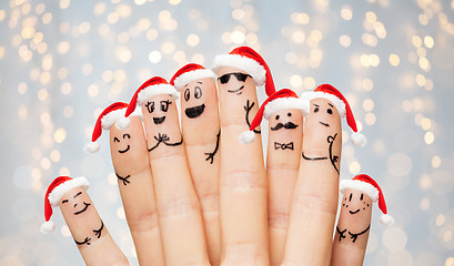 Image showing fingers with smiley faces and santa hats