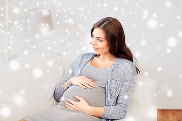 Image showing happy pregnant woman lying on sofa at home