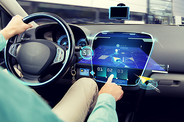 Image showing close up of man driving car with navigation system