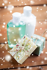 Image showing handmade soap bars and lotions on wood