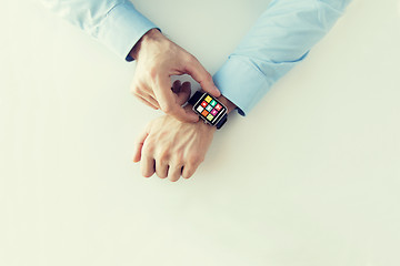 Image showing hands with application icons on smart watch