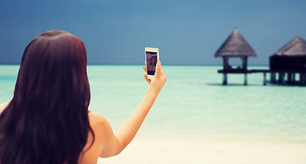 Image showing young woman taking selfie with smartphone