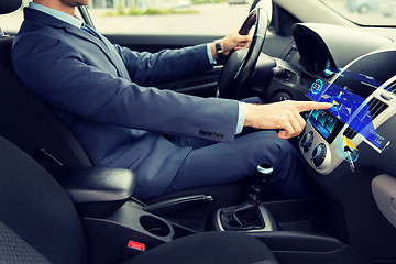 Image showing close up of man driving car with navigation