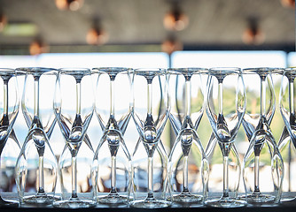 Image showing empty wine glasses set on shelf at restaurant