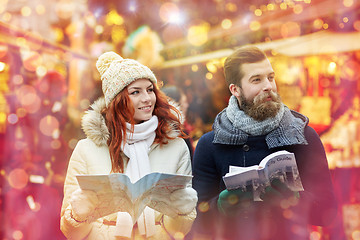 Image showing happy couple with map and city guide in old town