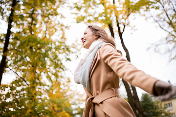 Image showing beautiful happy young woman walking in autumn park