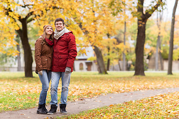 Image showing happy young couple walking in autumn park