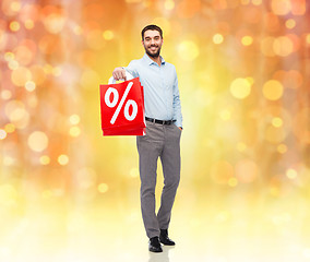 Image showing smiling man with red shopping bag