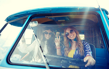 Image showing smiling young hippie women driving minivan car