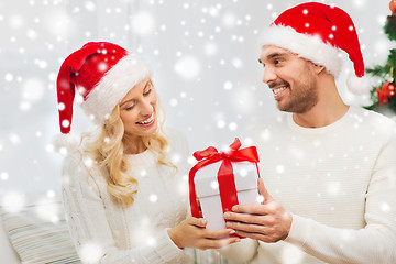 Image showing happy couple at home with christmas gift box