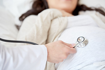 Image showing doctor with stethoscope and pregnant woman