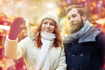 Image showing couple taking selfie with smartphone in old town