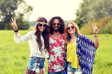 Image showing happy young hippie friends showing peace outdoors