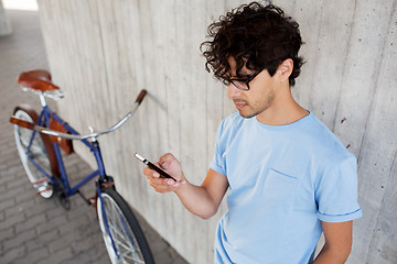 Image showing man with smartphone and fixed gear bike on street