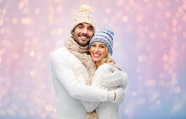 Image showing smiling couple in winter clothes hugging