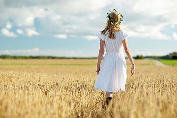 Image showing happy young woman in flower wreath on cereal field