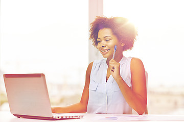 Image showing happy african woman with laptop at office