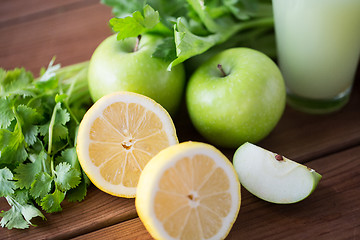 Image showing close up of lemons, apples, celery and green juice