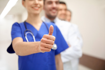 Image showing close up of doctors at hospital showing thumbs