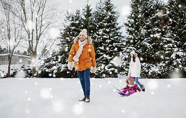 Image showing happy family with sled walking in winter outdoors