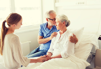 Image showing family visiting ill senior woman at hospital