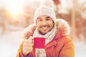 Image showing happy man with tea cup outdoors in winter