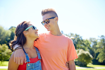 Image showing happy teenage couple looking at each other in park